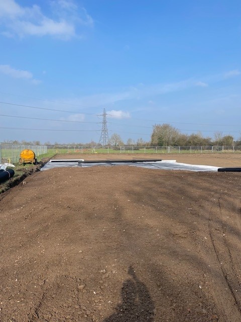 A completed construction access road showing a compacted aggregate base with clear surface markings.